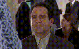 a man in a suit and tie is looking up at something