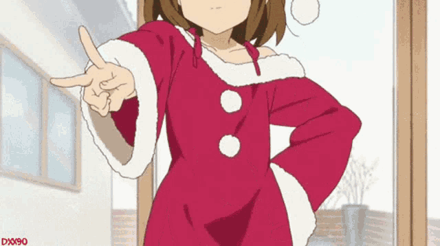 a girl in a santa outfit is pointing her finger at something