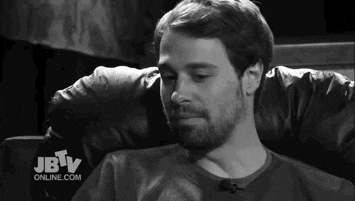 a man sitting in a chair with jbtv online.com on the bottom right