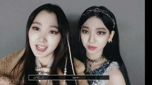 two girls are standing next to each other and one of them has the word giselle on it