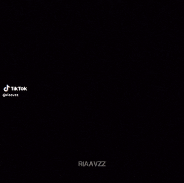 a blurry picture of a person 's face with riaavzz written on the bottom right corner