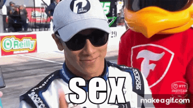 a man wearing sunglasses and a hat with the word sex on his shirt