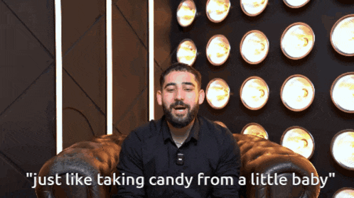 a man sitting in a chair with the words " just like taking candy from a little baby " on the bottom