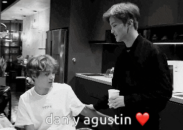 a black and white photo of two men with the words dan y agustin