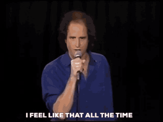 a man singing into a microphone with the words " i feel like that all the time " next to him