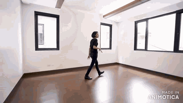 a woman is walking through an empty room with the words made in animotica on the bottom