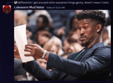 a man in a suit is holding a piece of paper in his hand