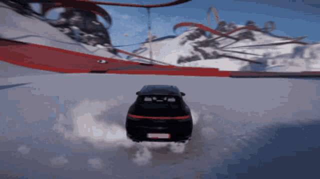 a car is driving down a snowy road with smoke coming out of the back