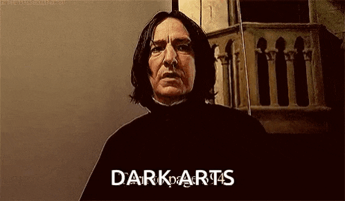 a man with long hair is standing in front of a building with the words `` dark arts '' written on his face .