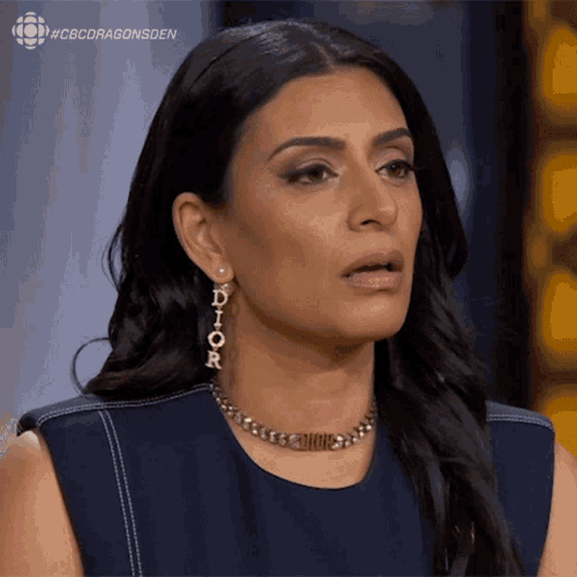 a woman wearing dior earrings and a dior choker