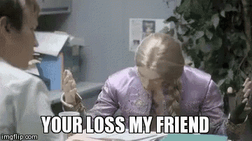 a woman in a purple dress is crying while sitting at a table with a man in a white shirt .