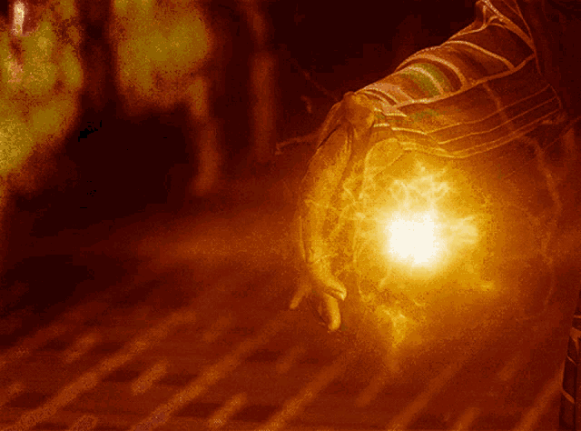 a close up of a person 's arm with a light coming out of it