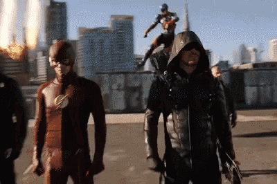 a man in a flash costume is standing next to an arrow costume