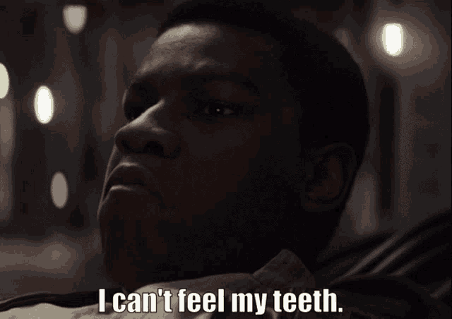 a close up of a man 's face with the words i can 't feel my teeth