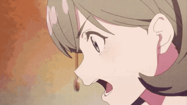 a close up of a anime girl 's face with her mouth open .