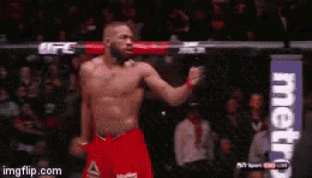 a man without a shirt is standing in a boxing ring with a metro sign in the background .