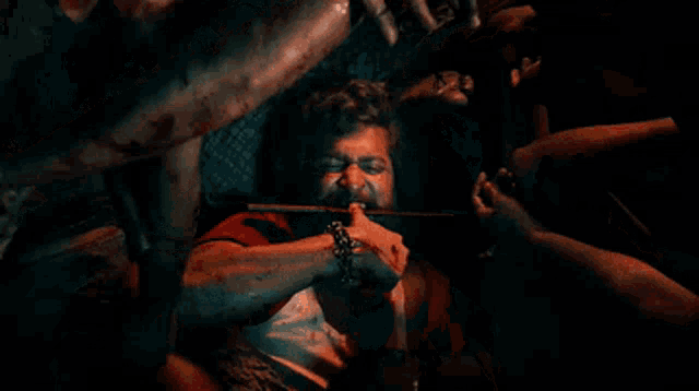 a man with blood on his face is holding a knife