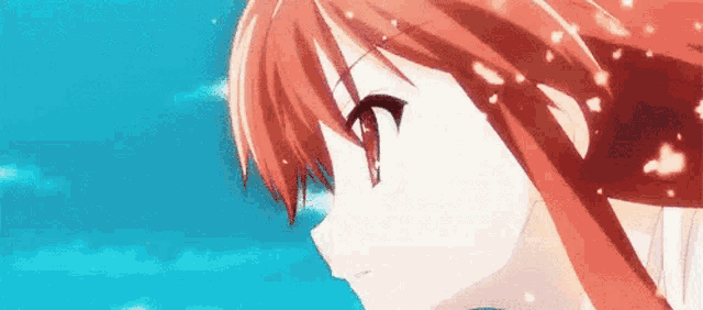 a close up of a red haired anime girl 's face with a blue sky in the background .