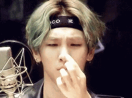 a man with green hair and a headband that says chanel on it