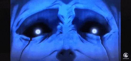 a close up of a man 's face with glowing eyes .