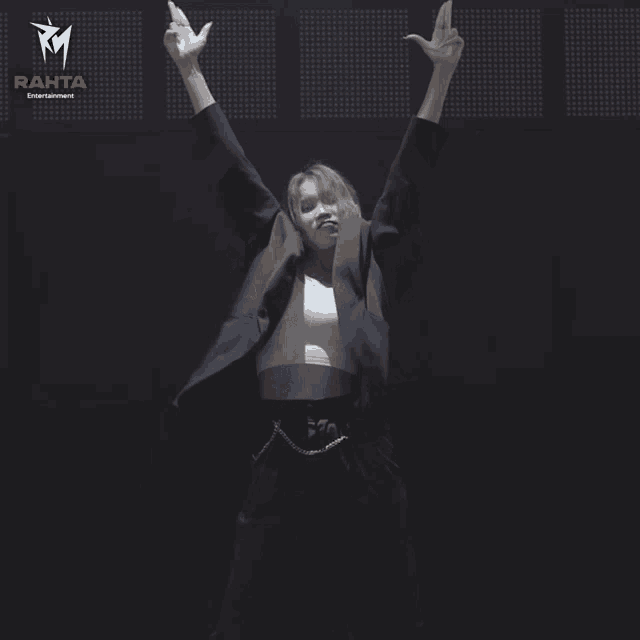 a woman is dancing in front of a rahta banner