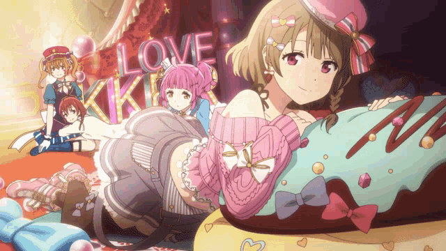 a girl in a pink sweater is laying on a pillow with the word love in the background