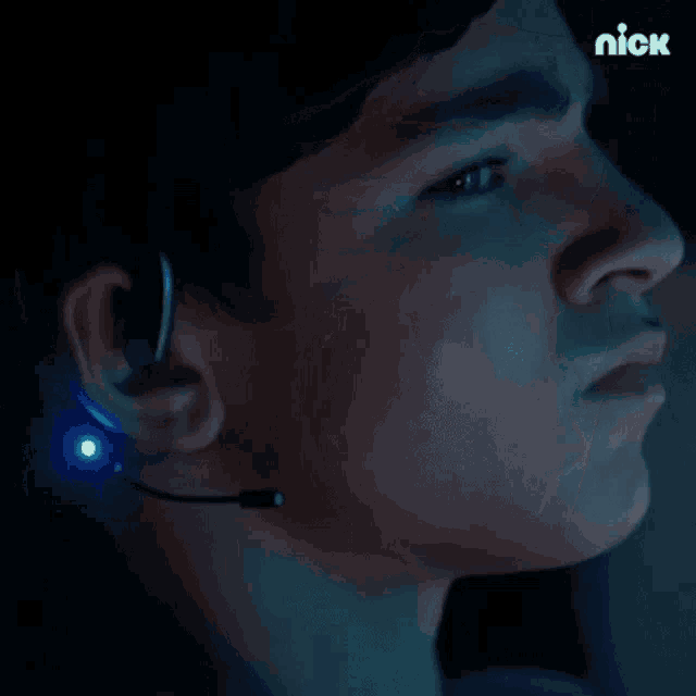 a close up of a young man wearing a headset .