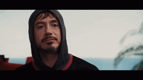 a man with a beard is wearing a hooded sweatshirt