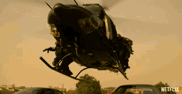 a helicopter is flying over a car with a netflix logo in the background