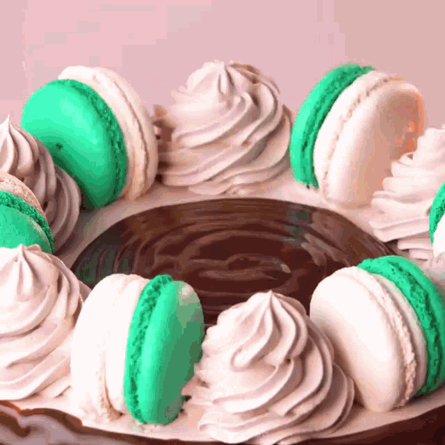 a cake with green macaroons and white frosting