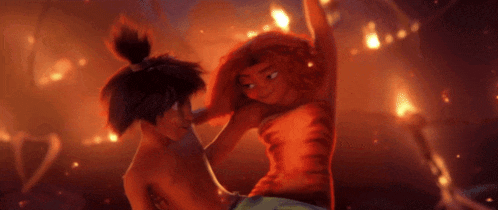 two cartoon characters are kissing in front of a fire .