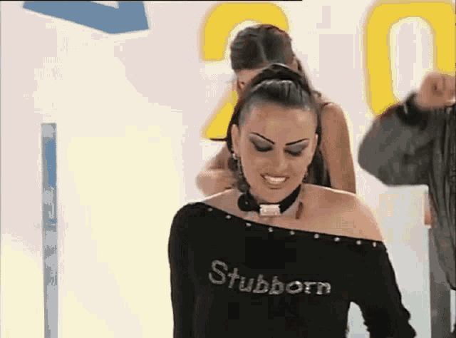 a woman wearing a black stubborn shirt is smiling