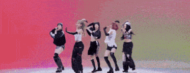 a group of women are standing in a circle with their arms in the air