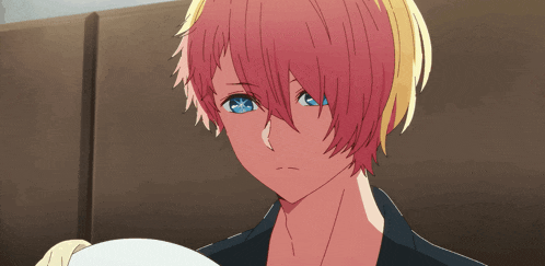 a girl with pink hair and blue eyes looks sad