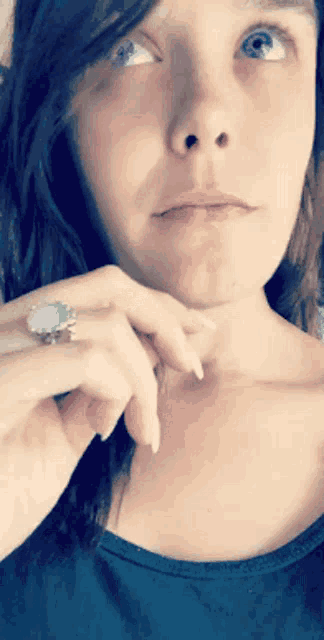 a woman wearing a turquoise ring on her left hand
