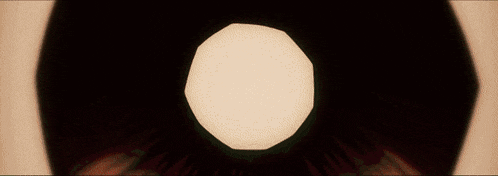a close up of an eye with a white circle in the middle