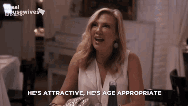 a woman says he 's attractive he 's age appropriate while sitting at a table