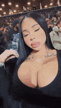 a woman with a tattoo on her chest that says ' i 'm a bitch '