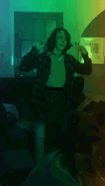 a woman in a plaid shirt is dancing in a room