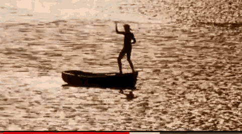a man stands on a boat in the water