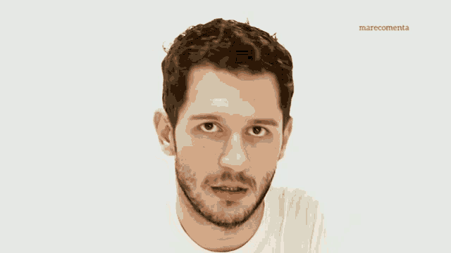 a man with a beard wears a white shirt