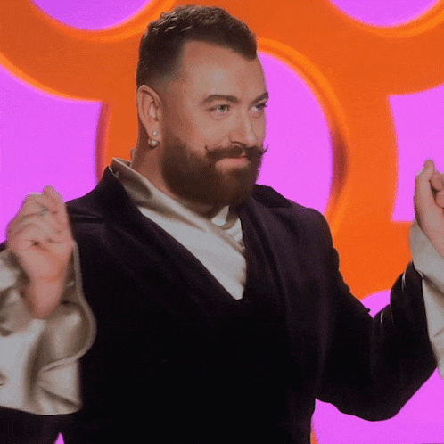 a man with a beard and mustache is wearing a suit