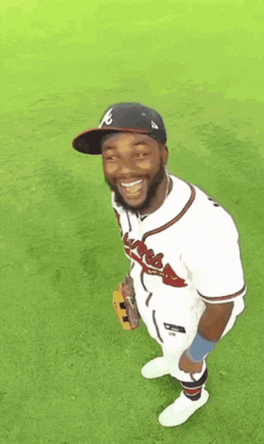 a baseball player wearing an atlanta braves uniform is smiling
