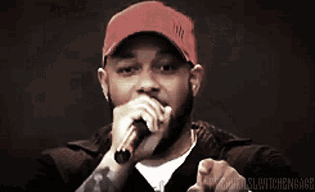 a man wearing a red hat is singing into a microphone with the words pybanki written below him
