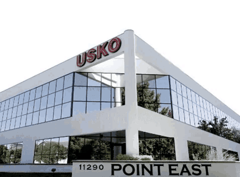 a white building with a sign that says point east