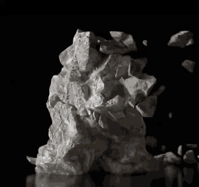 a pile of white rocks on a black surface