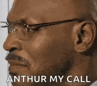 a bald man with glasses and a mustache is making a funny face and saying `` arthur my call '' .