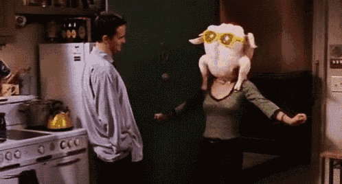a woman wearing sunglasses and a turkey head is dancing in a kitchen .