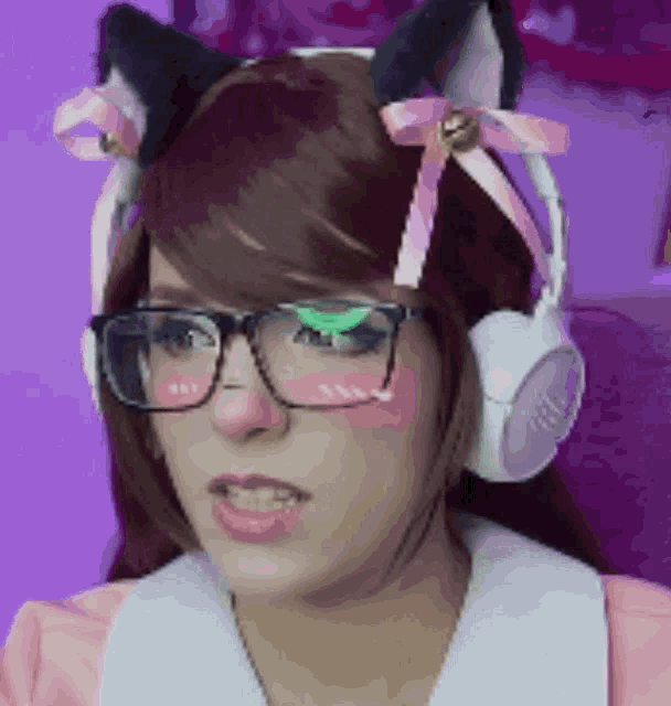a girl wearing glasses and headphones with cat ears