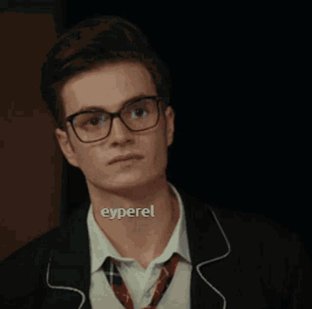 a man wearing glasses and a choker with the word eyperel on it